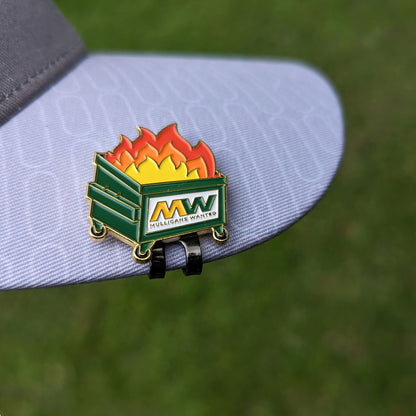 golf ball marker of dumpster on fire that says 'mulligans wanted' clipped to a hat