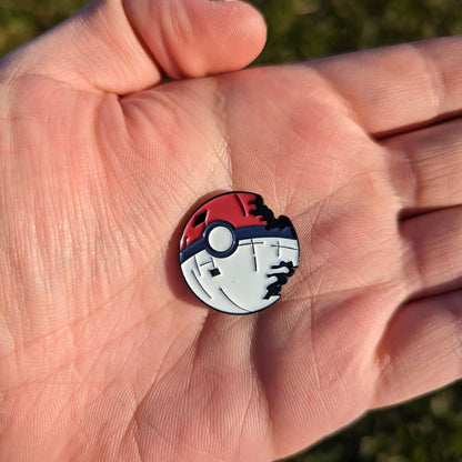 red and white poke star golf ball marker in hand