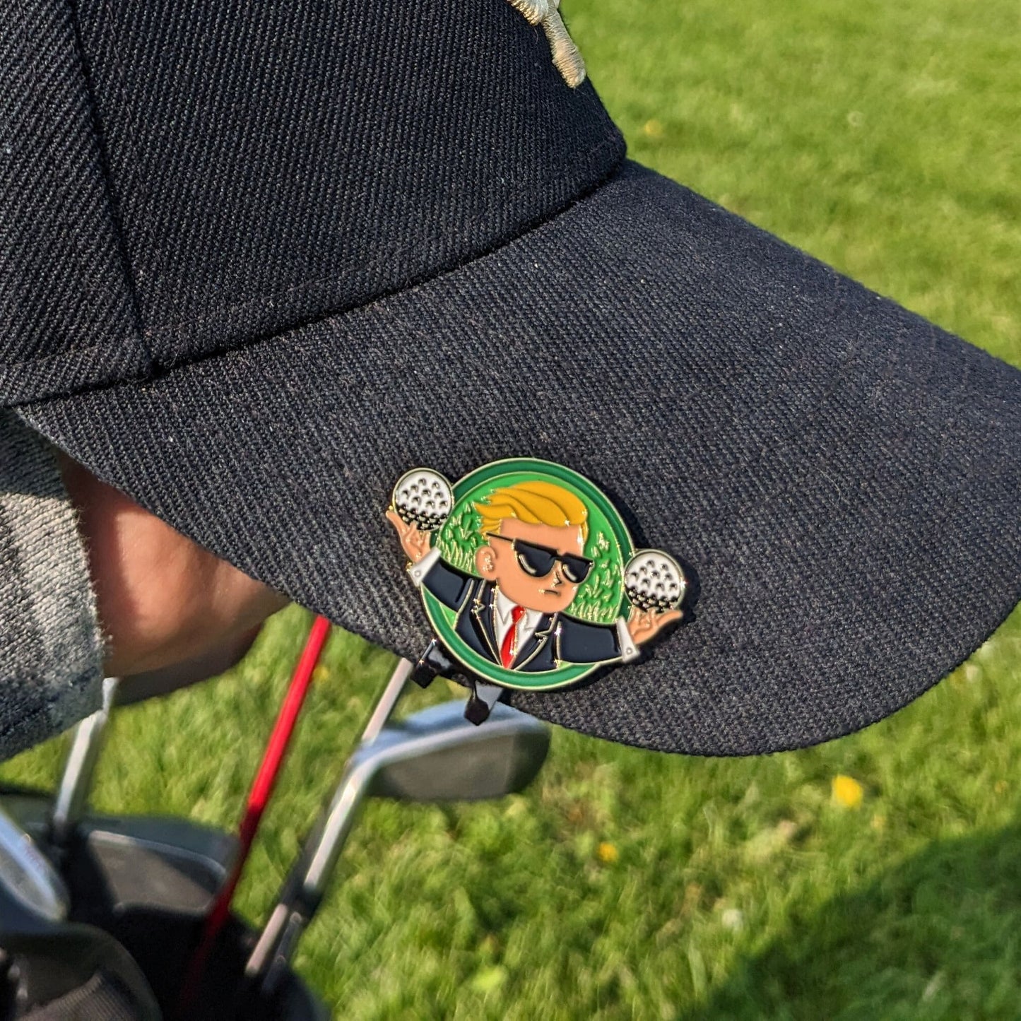 golf ball marker of wall street bets the kid holding golf balls clipped on hat